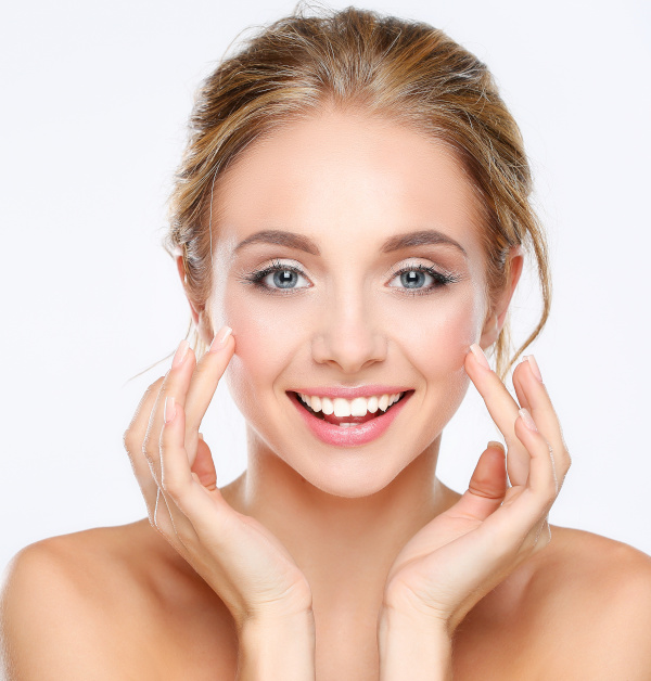 Young woman touching her face isolated on white background